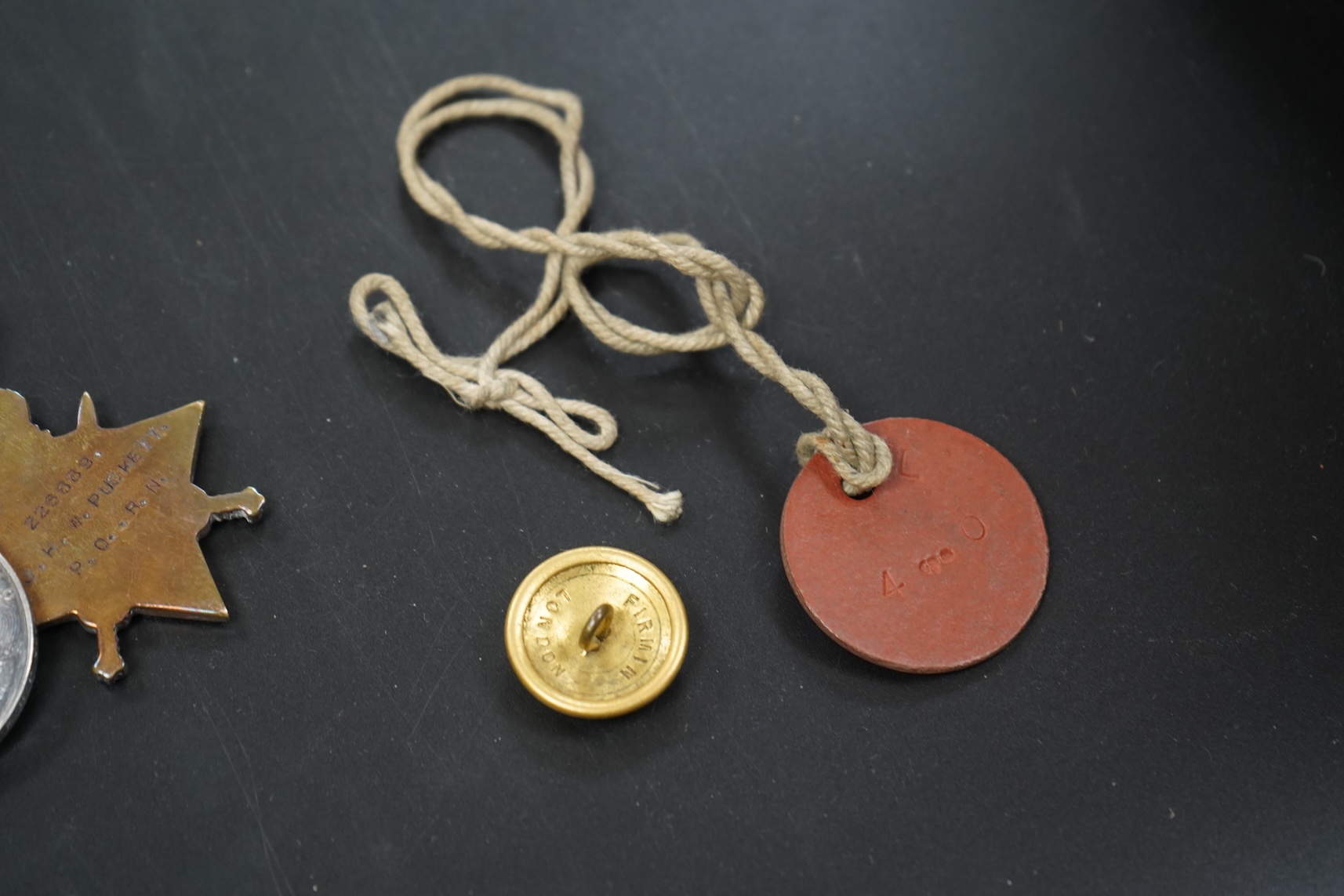 A WWI medal group including Good Conduct awarded to 226989 JHW.PUCKETT.PO.RN. (HMS PEMBROKE) together with cloth badges and a tag